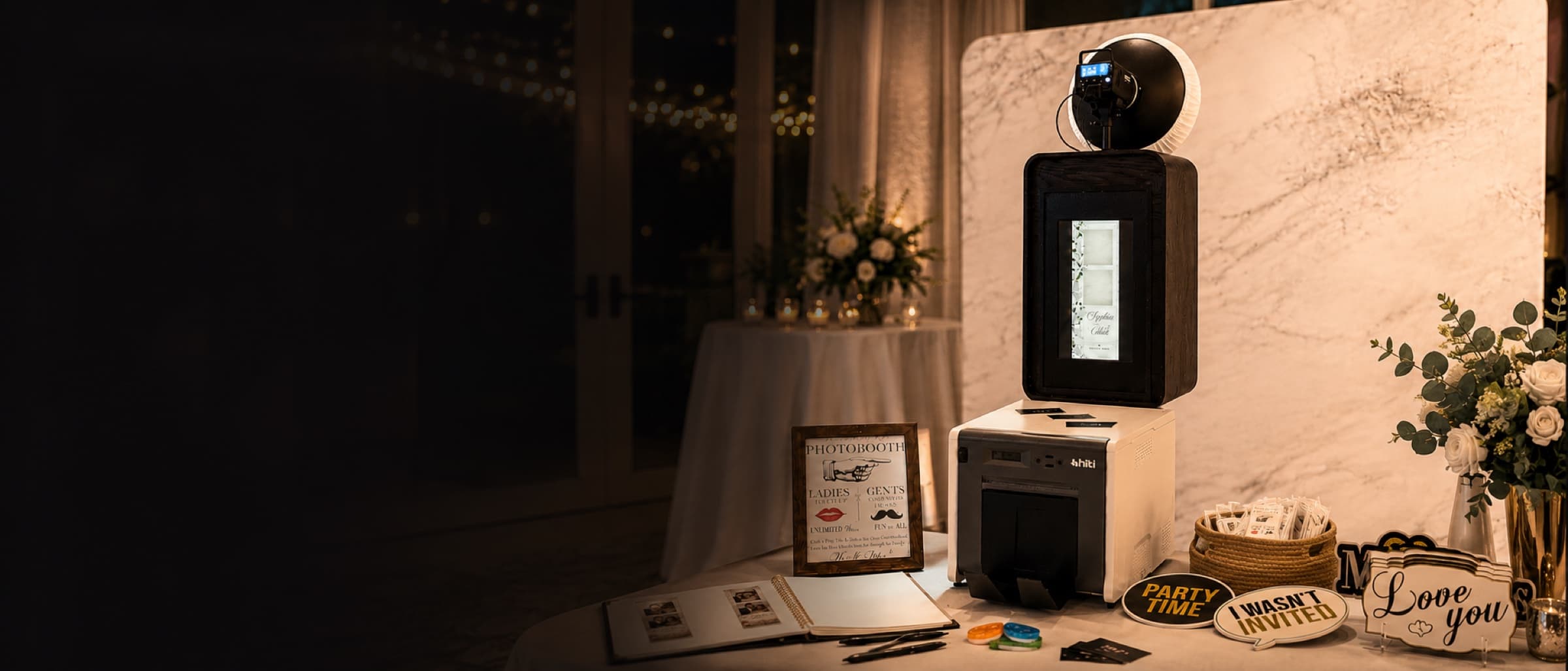 Premium photo booth, printer, guestbook, and props at an elegant wedding reception